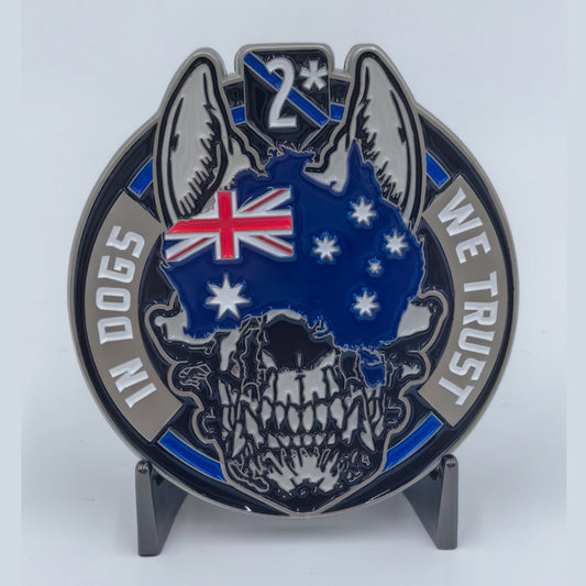 In Dogs We Trust challenge coin, law enforcement side — thin blue line with Australian map and flag, skull framed by working dog ears.